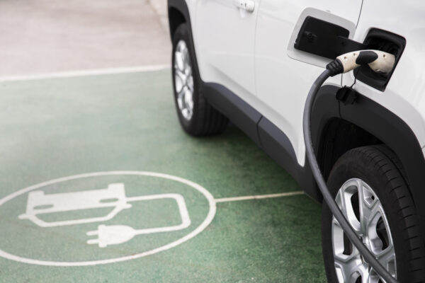 Close up of car charging, a symol on the floor identifies that the parking spaec is for EVs only